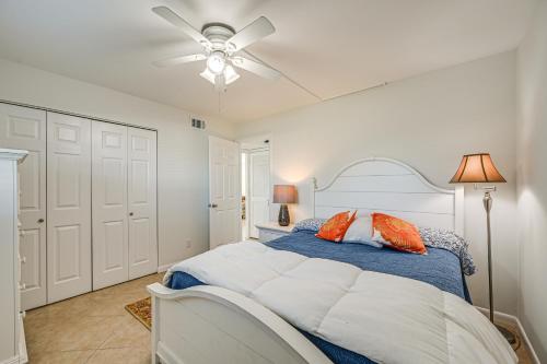 a bedroom with a bed and a ceiling fan at Lanai and Golf Course View Cozy Condo in Naples! in Naples