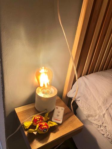 a candle on a table next to a bed at Blue Ocean in Mar del Plata