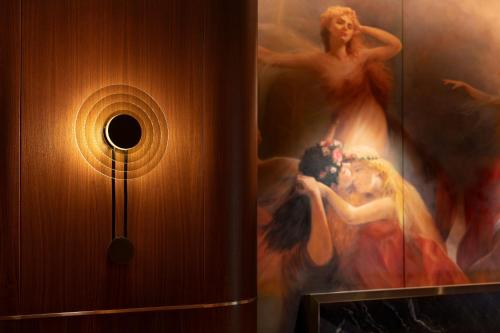 a wall with a painting of a woman on a wall at The St. Regis Belgrade in Belgrade