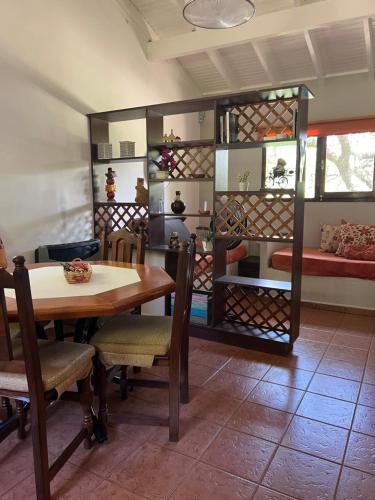 a room with a table and chairs and a bed at Cabañas La Frontera in Villa General Belgrano