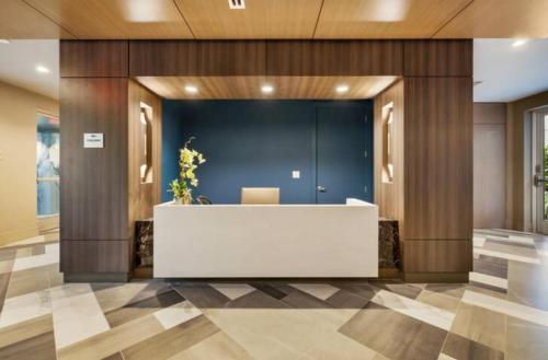 an office lobby with a white reception desk at Resort-Style Apartments near The Galleria in Houston