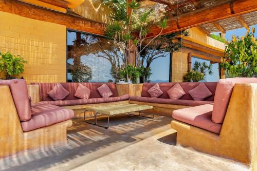 a living room with pink couches and a table at Casa El Santuario in Valle de Bravo