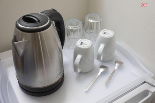 a coffee pot sitting on top of a counter with spoons at ATHENS COMMERCIAL in Athens