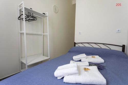 a bedroom with a bed with towels on it at ATHENS COMMERCIAL in Athens