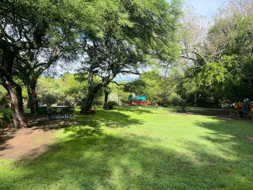 a park with a picnic table and a playground at Cabañas La Frontera in Villa General Belgrano