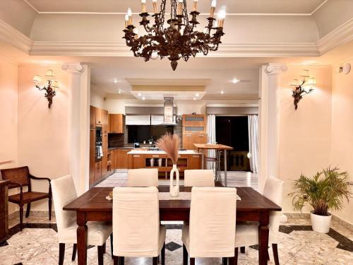 a dining room and kitchen with a table and chairs at Madliena Hills Mansion in Is-Swieqi