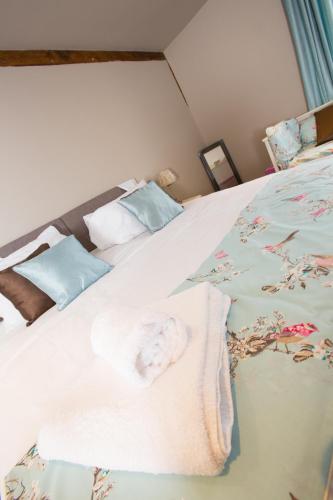 a bedroom with a bed with towels on it at The Harvard Inn in Stock