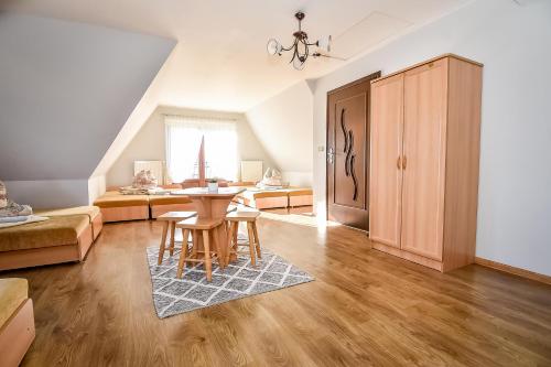 a living room with a table and a couch at Marysieńka Pokoje Hrube Wyżne 12A in Zakopane