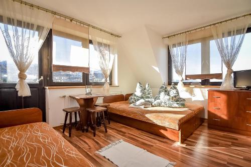 a bedroom with a bed and a desk and a table at Marysieńka Pokoje Hrube Wyżne 12A in Zakopane