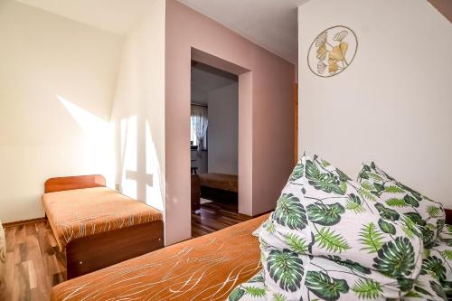 a bedroom with a bed with a pillow on it at Marysieńka Pokoje Hrube Wyżne 12A in Zakopane