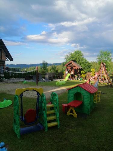 a park with a playground with a slide and a swing at Marysieńka Pokoje Hrube Wyżne 12A in Zakopane