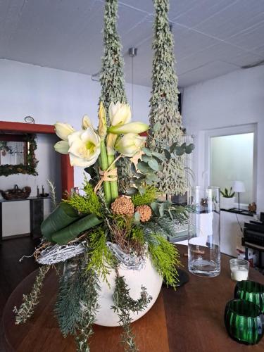 a vase filled with flowers on top of a table at Landhauskiebel in Erden