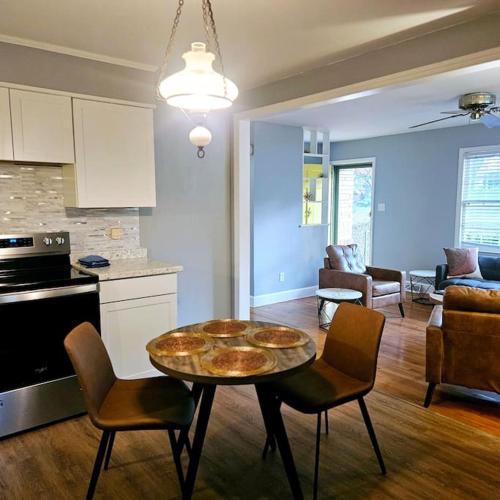 a kitchen and a living room with a table and chairs at Charming Charlotte city Vacation Home in Charlotte