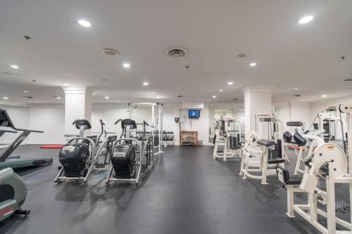 a gym with several treadmills and tread machines at Century Plaza Hotel in Vancouver