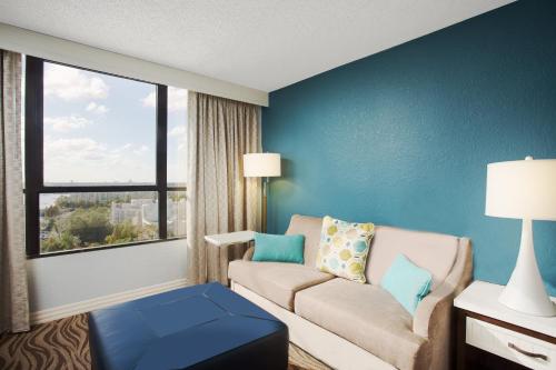 a living room with a couch and a window at Wyndham Lake Buena Vista – Disney Springs® Area in Orlando