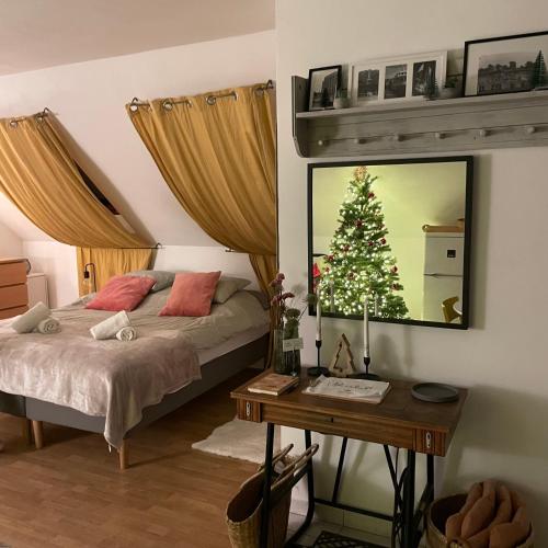 a bedroom with a bed and a christmas tree on the wall at Panorama Wine & Chill in Hévíz
