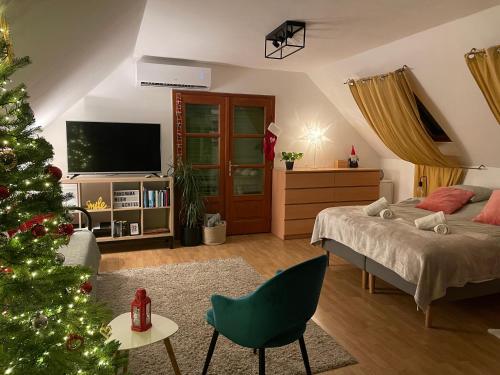 a bedroom with a christmas tree and a bed at Panorama Wine & Chill in Hévíz