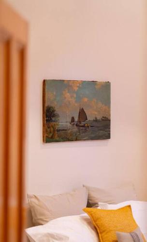 a painting hanging on a wall above a couch at Signal Cottage close to beach and Semaphore Road in Semaphore