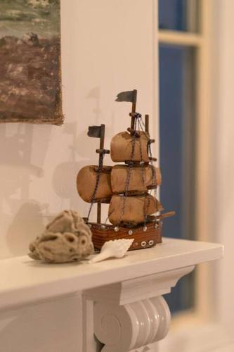 a small pirate ship sitting on a table at Signal Cottage close to beach and Semaphore Road in Semaphore