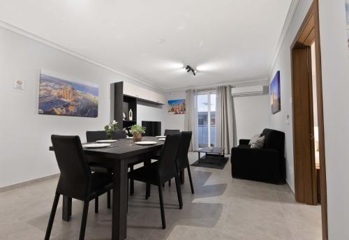 a dining room and living room with a table and chairs at Luxurious & Spacious 2BD Accomodation at The Podium - Yacht Marina Area, Close to Valletta in Msida