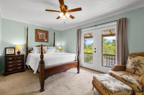 a bedroom with a bed and a ceiling fan at Biltmore Beach Townhouse! in Panama City Beach