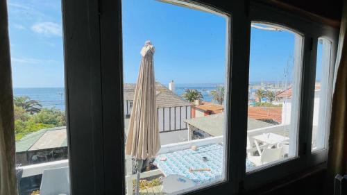 a view from a window of a pool and an umbrella at Casa Almar in Algarrobo