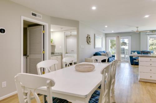 a kitchen and dining room with a white table and chairs at Emerald Isle Condo with Indoor Pool and Beach Access! in Emerald Isle