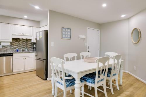 a kitchen and dining room with a white table and chairs at Emerald Isle Condo with Indoor Pool and Beach Access! in Emerald Isle