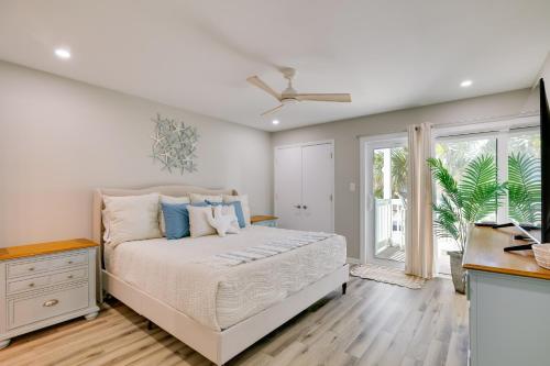 a bedroom with a bed with blue pillows at Emerald Isle Condo with Indoor Pool and Beach Access! in Emerald Isle