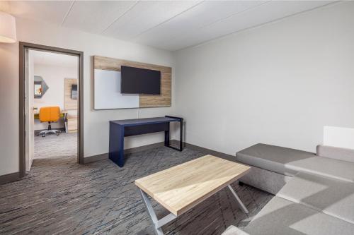 a living room with a couch and a table at La Quinta by Wyndham Lexington Park - Patuxent in California