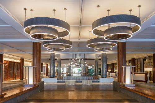 a lobby with chandeliers and tables in a building at Sheraton Fiji Golf & Beach Resort in Denarau