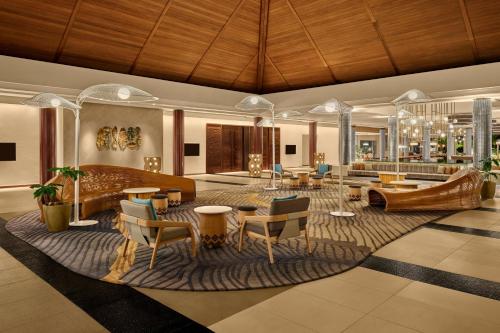 a hotel lobby with a piano and tables and chairs at Sheraton Fiji Golf & Beach Resort in Denarau