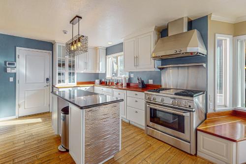a kitchen with white cabinets and a stove top oven at The Lake Labyrinth in Zephyr Cove