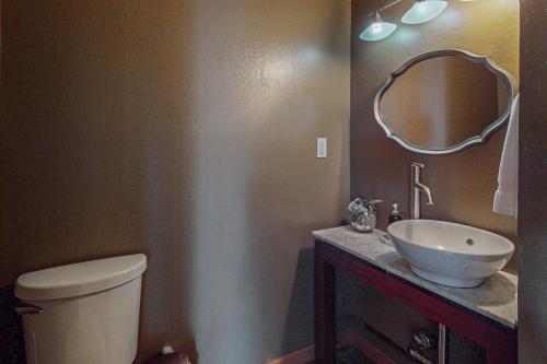 a bathroom with a toilet and a sink and a mirror at The Lake Labyrinth in Zephyr Cove