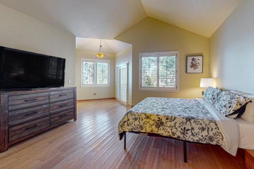 a bedroom with a bed and a flat screen tv at The Lake Labyrinth in Zephyr Cove