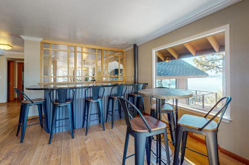 a kitchen with blue stools and a bar with a view at The Lake Labyrinth in Zephyr Cove
