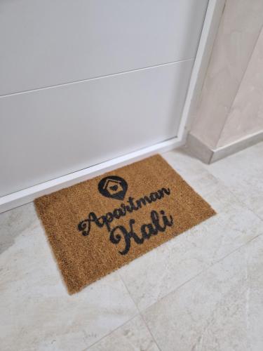 a welcome mat on the floor of a room at Apartman Kali Srebrno jezero in Ostrovo