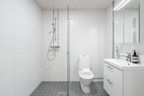 a bathroom with a shower and a toilet and a sink at Modern 1BR Apartment in Kaleva next to Tram Line in Tampere