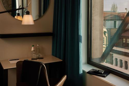 a room with a window with a table and a chair at The Cloud One Gdansk in Gdańsk