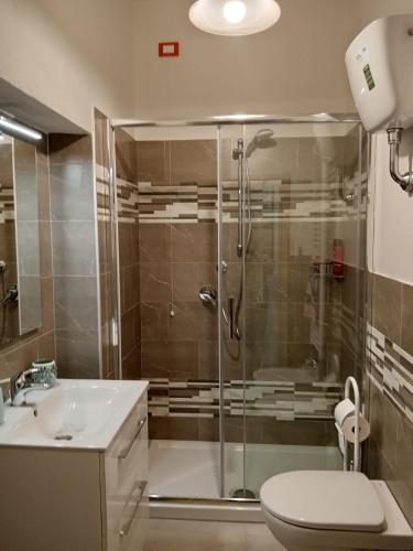 a bathroom with a shower and a toilet and a sink at La Poltrona del Diavolo in Montenero
