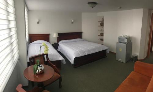 Postel nebo postele na pokoji v ubytování Altura Rooms & Suites