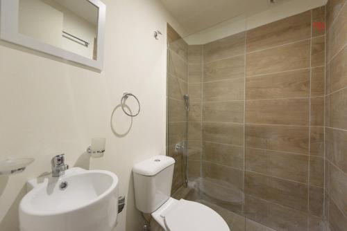 a bathroom with a toilet and a sink and a shower at ATHENS COMMERCIAL in Athens