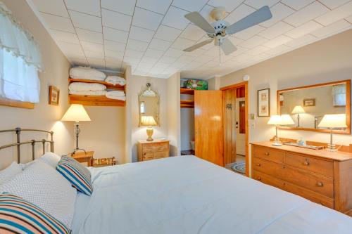 a bedroom with a bed and a ceiling fan at Walk to Beach Long Island Wine Country Home! in Cutchogue