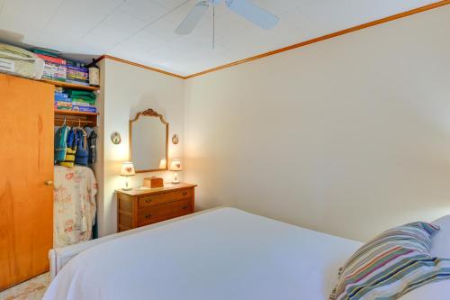 a bedroom with a bed and a dresser and a mirror at Walk to Beach Long Island Wine Country Home! in Cutchogue