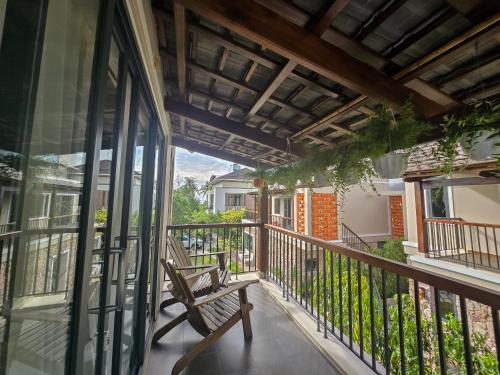 a balcony with a wooden bench on a porch at Sealight Villa and House Phu Quoc in Phu Quoc