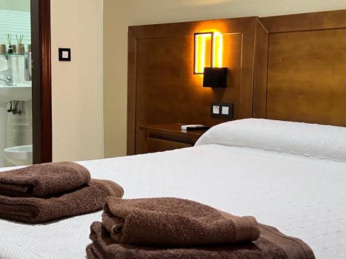Ένα ή περισσότερα κρεβάτια σε δωμάτιο στο Hotel Don Juan