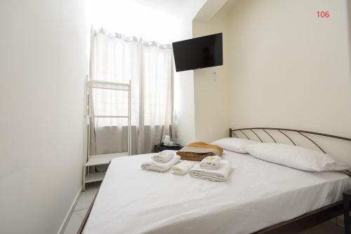 a bedroom with a bed with towels on it at ATHENS COMMERCIAL in Athens