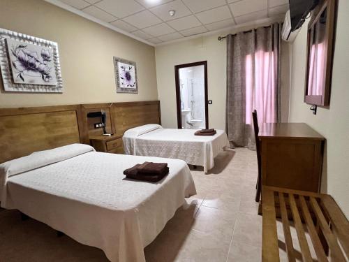 Ένα ή περισσότερα κρεβάτια σε δωμάτιο στο Hotel Don Juan