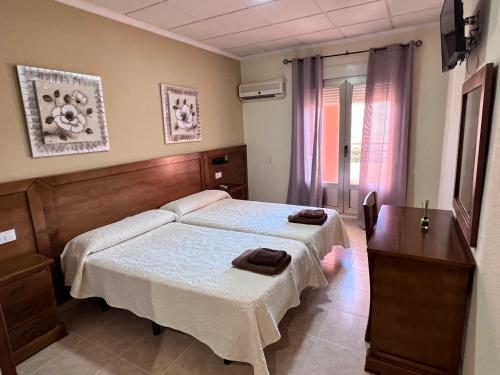 Ένα ή περισσότερα κρεβάτια σε δωμάτιο στο Hotel Don Juan