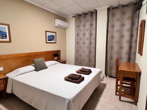 Ένα ή περισσότερα κρεβάτια σε δωμάτιο στο Hotel Don Juan